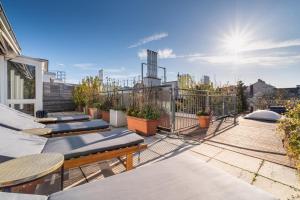 a balcony with chaise lounges on a building at Sky Garden Vienna in Vienna