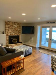 a living room with a couch and a fireplace at The Riptide Retreat in Shelton