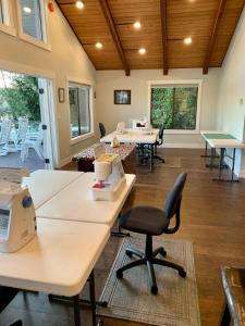 a waiting room with desks and chairs and windows at The Riptide Retreat in Shelton