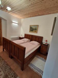 a bedroom with a wooden bed in a room at Dům u Giordanu in Slavonice