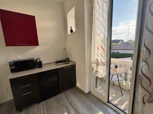 a small kitchen with a counter and a balcony at Casa di Mile in Rho