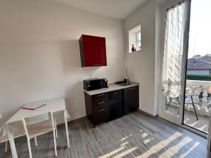 a small kitchen with a table and a microwave at Casa di Mile in Rho +11 photos