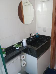 a bathroom counter with a sink and a mirror at Casa Bella in Catanduva +25 photos
