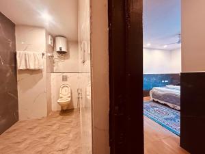 a bathroom with a toilet and a bed in a room at Most Awarded Property In Mussoorie in Mussoorie +59 photos