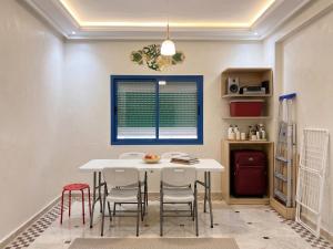 a dining room with a white table and chairs at Sidi Rahal Playa beach in Casablanca