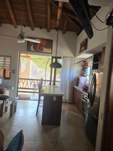 a kitchen with a table and a dining room at Condominio Dario 12 in Zihuatanejo
