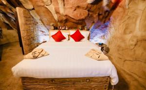 a bedroom with a bed in a stone wall at Bedouin Life Camp in Aqaba +9 photos