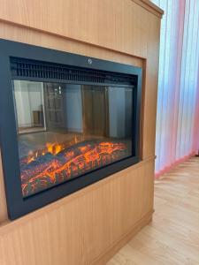 a fireplace with a fire inside of it at Foresta Home in Gradačac