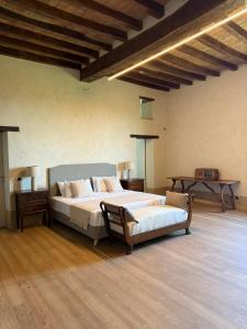 a large bedroom with two beds and a table at La Torre Masana in Vigostano