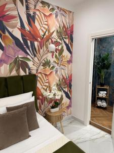 a bedroom with a floral wallpaper on the wall at Savior Deluxe Rooms in Naples +42 photos