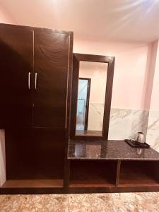 a black cabinet with a mirror in a room at Most Awarded Property In Mussoorie in Mussoorie
