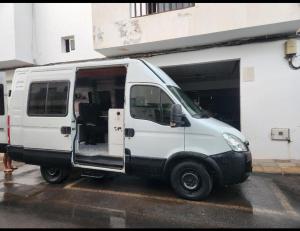 a white van parked in a parking lot at Furgocamper in Lanzarote