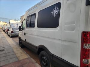 a white van parked on the side of a street at Furgocamper in Lanzarote