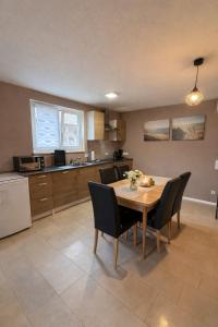 a kitchen and dining room with a table and chairs at Kuzey Apartments in Kappel-Grafenhausen +62 photos