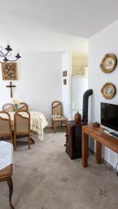 a living room with a tv and a table and a kitchen at Međugorje Quit Hideaway in Botići
