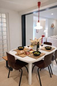 a white table with food on it in a living room at Acmé Appartement 200 m du lac d'Annecy in Angon