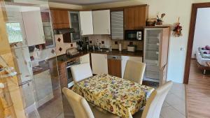 a kitchen with a table and chairs and a table and a table and chairsktop at Mézi Lazy in Gyenesdiás