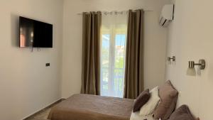 a bedroom with a bed and a window at Marili Apartments in Roda