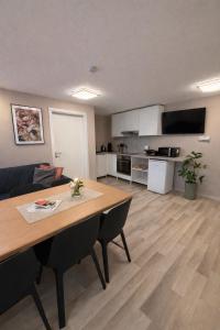a living room with a table and a kitchen at Kuzey Apartments in Kappel-Grafenhausen