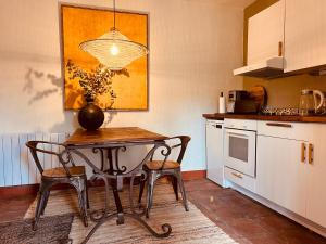a kitchen with a table and two chairs in it at Boutique Finca Stay in Nature in Mijas