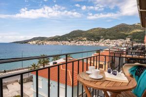 a balcony with a table and a view of the ocean at SeaView City in Samos