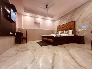 a bedroom with a bed and a tv on a wall at Most Awarded Property In Mussoorie in Mussoorie