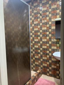 a shower with a glass door in a bathroom at Nukriani Keiptauni Residence in Sighnaghi +23 photos
