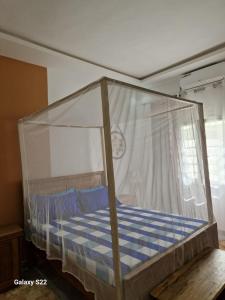 a bed with a clear canopy in a room at Villa Aria in Mbour +21 photos