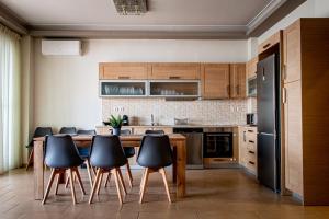 a kitchen with a wooden table and black appliances at Marathon Coastal House in Marathon