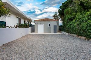 a house with a driveway in front of a building at Marathon Coastal House in Marathon