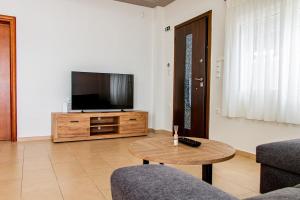 a living room with a television and a coffee table at Marathon Coastal House in Marathon