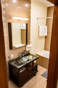 a bathroom with a sink and a mirror and a tub at Marathon Coastal House in Marathon +16 photos