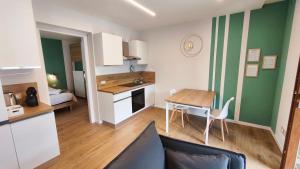 a kitchen and a living room with a table and a dining room at San Martì Casa Vacanze in Piazza Brembana
