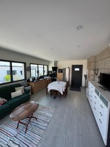 a living room with a green couch and a table at Quinta do Olival Amarante in Gatão