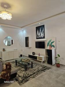 a living room with a couch and a table at Villa Aria in Mbour