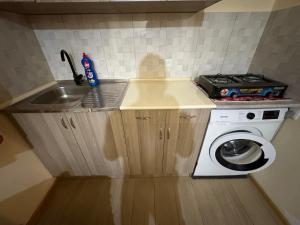 a small kitchen with a sink and a washing machine at Hotel MANTASHOV in Meghri