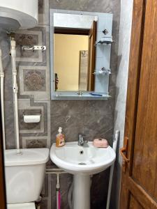 a bathroom with a sink and a toilet and a mirror at Hotel MANTASHOV in Meghri