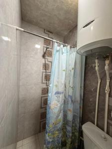 a bathroom with a shower with a shower curtain at Hotel MANTASHOV in Meghri