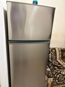 a stainless steel refrigerator with a blue top at Hotel MANTASHOV in Meghri
