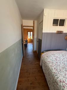 a bedroom with a bed and a hallway at File dans ta chambre ! in Le Monastier sur Gazeille