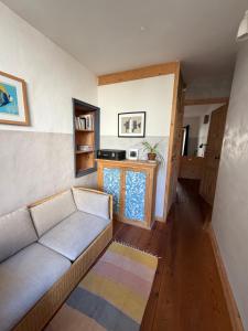 a living room with a couch and a table at File dans ta chambre ! in Le Monastier sur Gazeille +24 photos