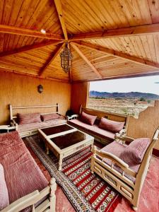a room with two beds and chairs and a roof at Hotel la renaissance tata in Tatta