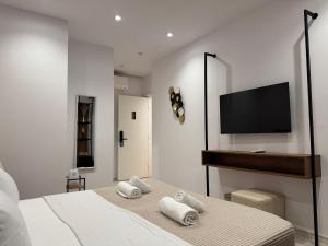 a bedroom with a bed and a flat screen tv at Hotel Veizi in Himare +36 photos