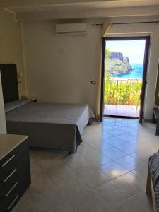 a bedroom with two beds and a view of the ocean at Hotel Normanni in Praia a Mare