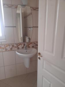a bathroom with a sink and a mirror at Kings and Queens 1 in Larisa +9 photos