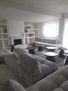 a large living room with a couch and tables at Kings and Queens 1 in Larisa