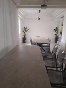 a table and chairs in a room with a laptop on it at Kings and Queens 1 in Larisa