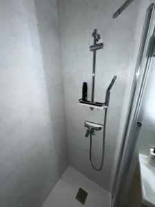 a shower in a bathroom with a shower head at Deniz’s Serviced Apartment. in Niederaula +12 photos