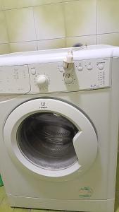 a white washing machine with its door open at النور للاستثمار العقاري بالمنيل in Cairo +13 photos