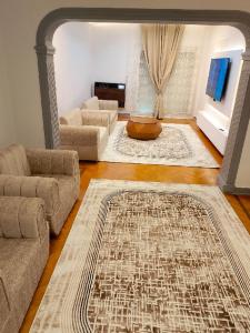 a living room with two couches and a rug at النور للاستثمار العقاري بالمنيل in Cairo